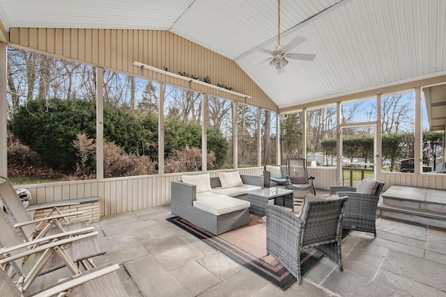 sunroom / solarium featuring ceiling fan and vaulted ceiling