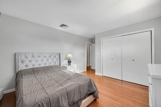 bedroom featuring hardwood / wood-style floors and a closet