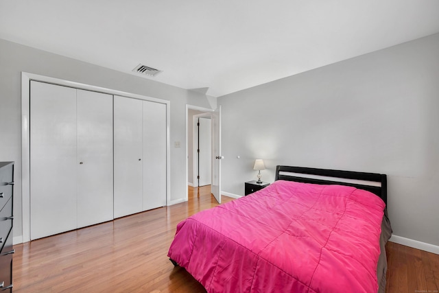 bedroom with hardwood / wood-style flooring and a closet