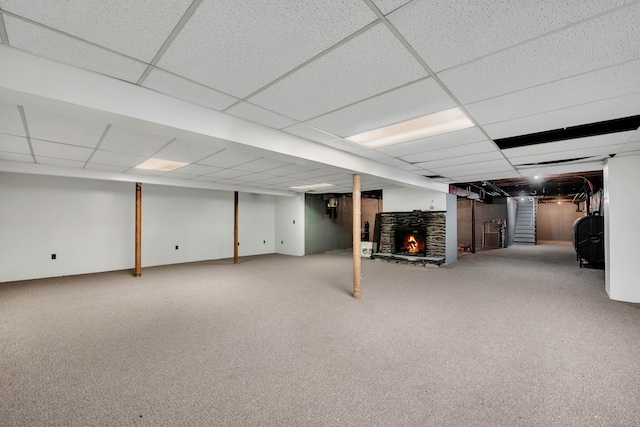 basement with a drop ceiling and carpet floors