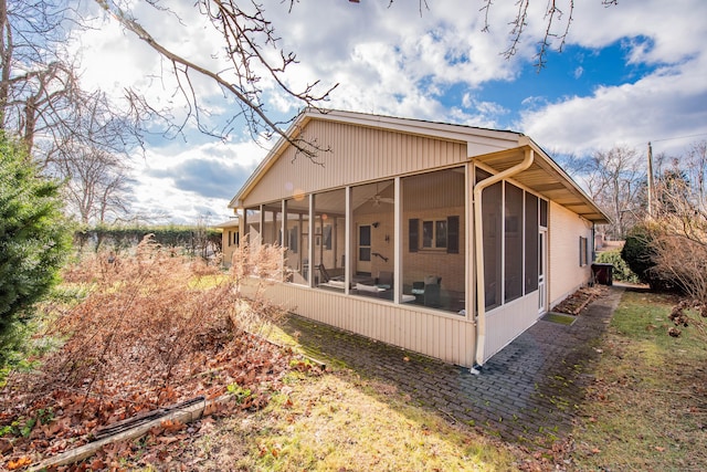 view of home's exterior with a sunroom