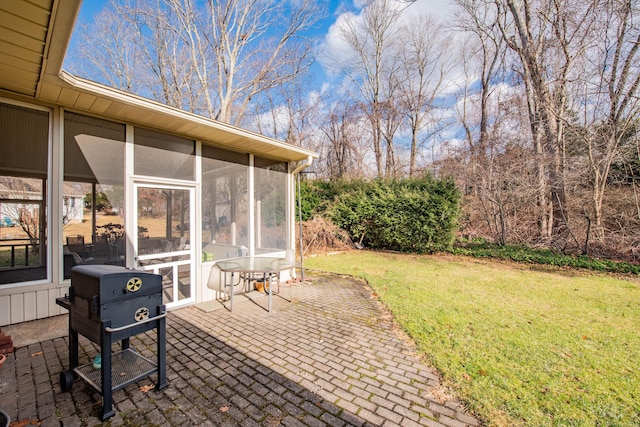 view of yard featuring a sunroom and a patio