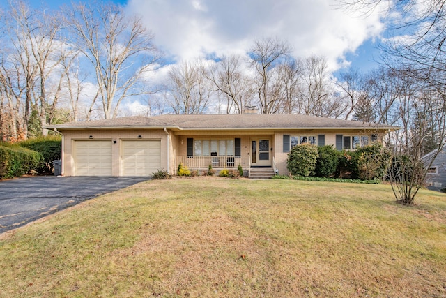 ranch-style house with a front yard, a garage, and covered porch