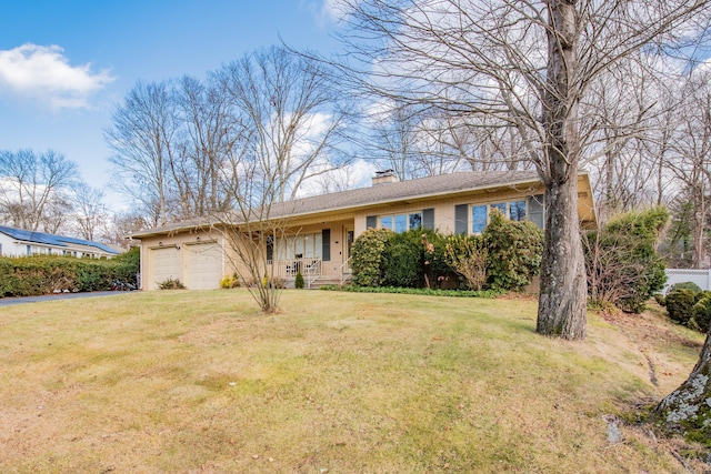 single story home with a front yard and a garage