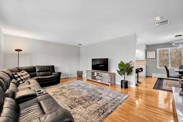 living room featuring light hardwood / wood-style flooring and baseboard heating