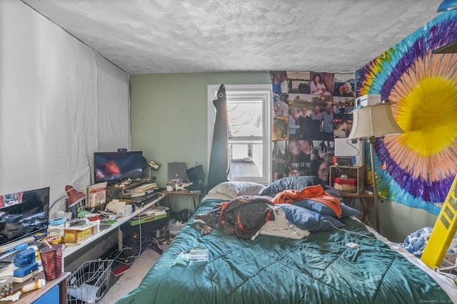 carpeted bedroom featuring a textured ceiling