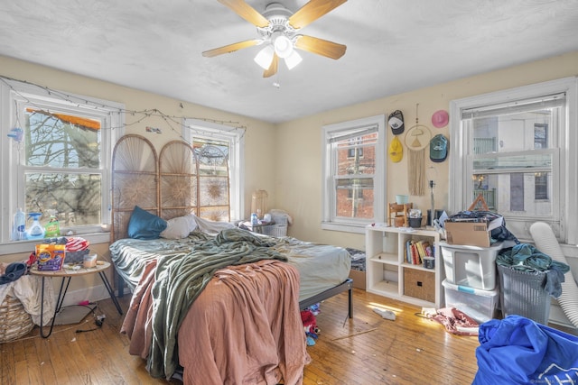 bedroom with wood-type flooring and ceiling fan