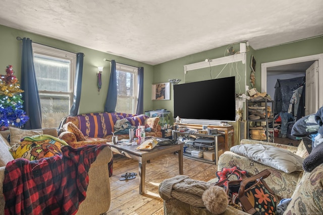 living room featuring a textured ceiling and light wood-type flooring