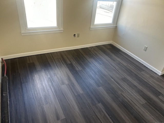 unfurnished room featuring dark wood-type flooring