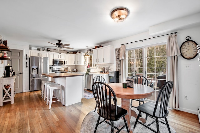 dining room featuring ceiling fan and light hardwood / wood-style flooring