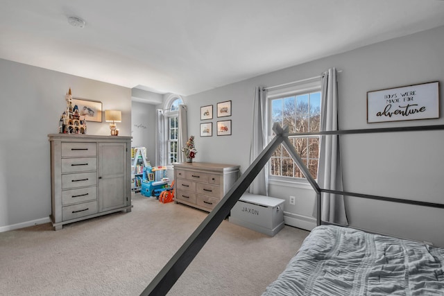 carpeted bedroom featuring a baseboard radiator