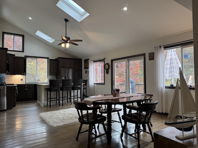 dining space featuring plenty of natural light, dark wood-type flooring, ceiling fan, and a skylight