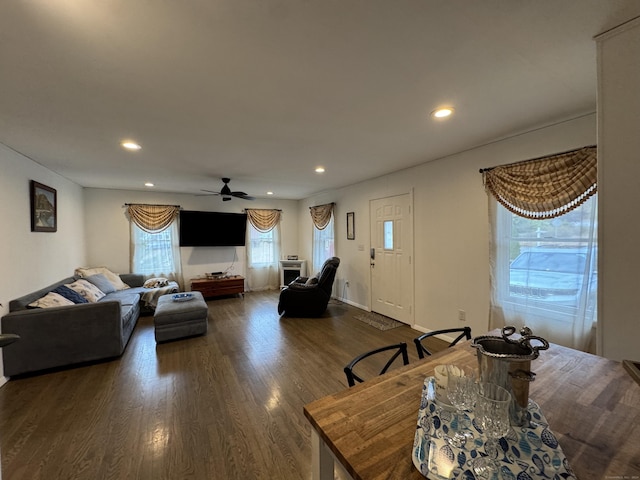 living room featuring dark hardwood / wood-style flooring and ceiling fan