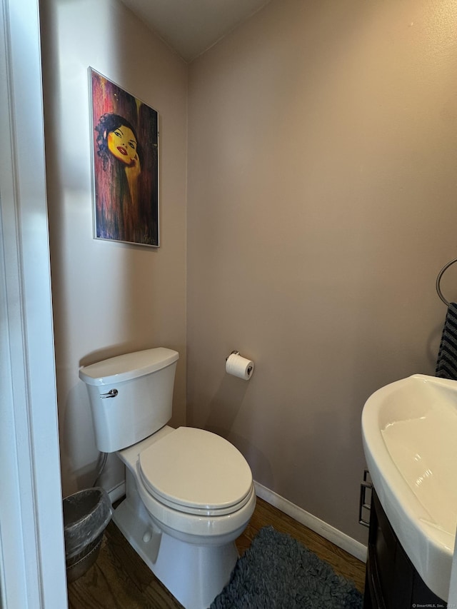 bathroom featuring hardwood / wood-style floors, sink, and toilet