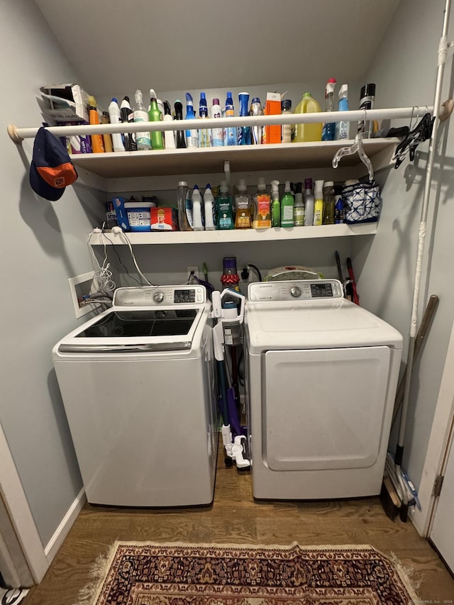 laundry room with dark wood-type flooring and washer and dryer