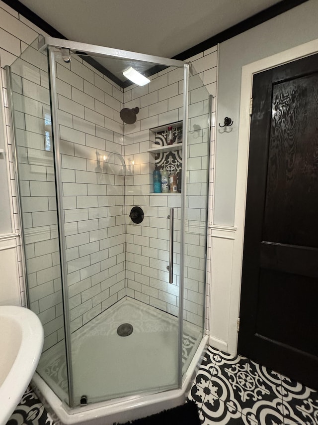 bathroom featuring an enclosed shower and tile patterned floors