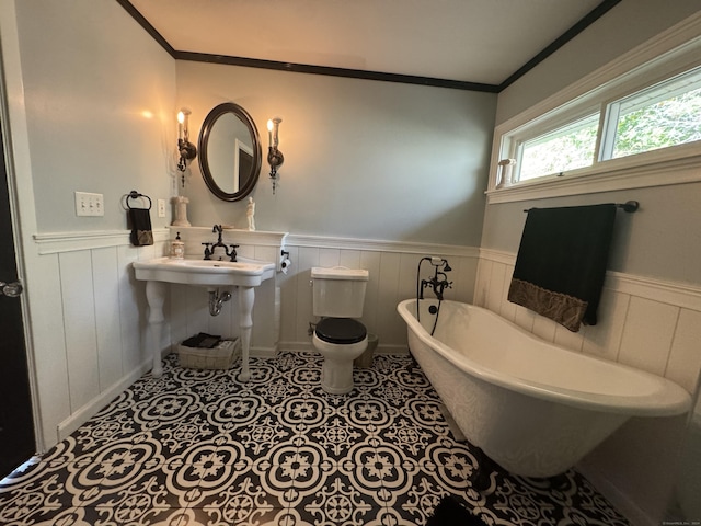 bathroom featuring ornamental molding, tile patterned floors, and a bathing tub