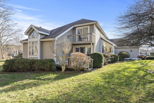 view of side of property featuring a yard and a balcony