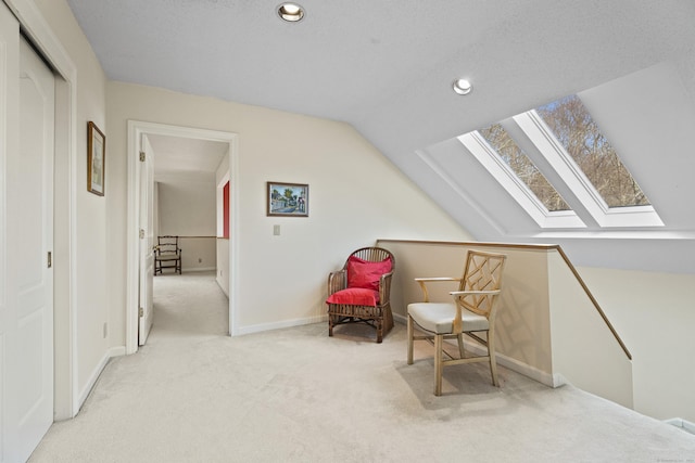 sitting room featuring light carpet and vaulted ceiling