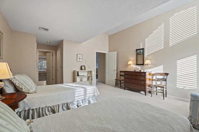 bedroom featuring a textured ceiling and light carpet