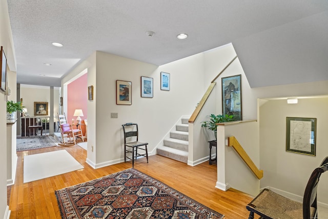 foyer with hardwood / wood-style floors and a textured ceiling