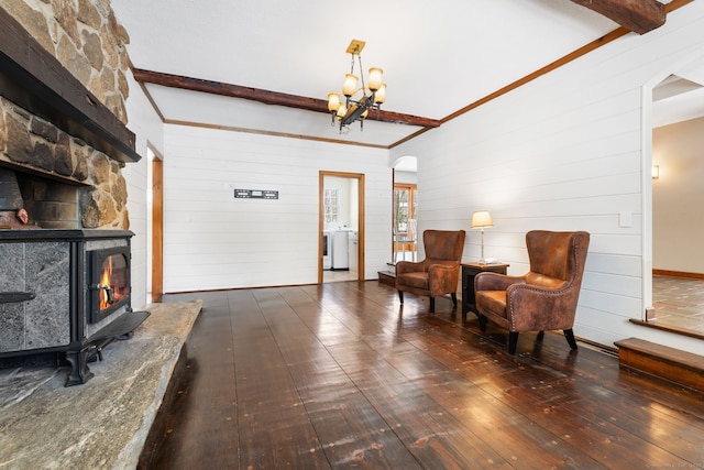 sitting room with dark hardwood / wood-style flooring, a notable chandelier, washer / clothes dryer, and beamed ceiling