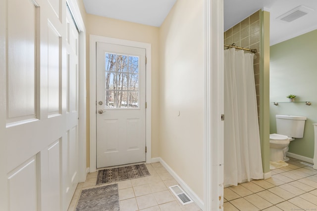 entryway with light tile patterned floors