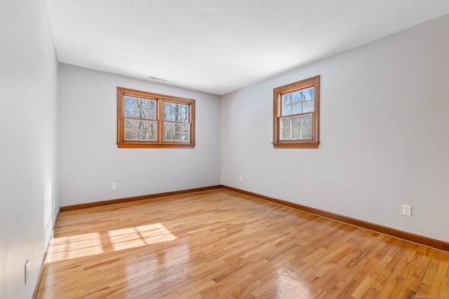 spare room featuring light wood-type flooring