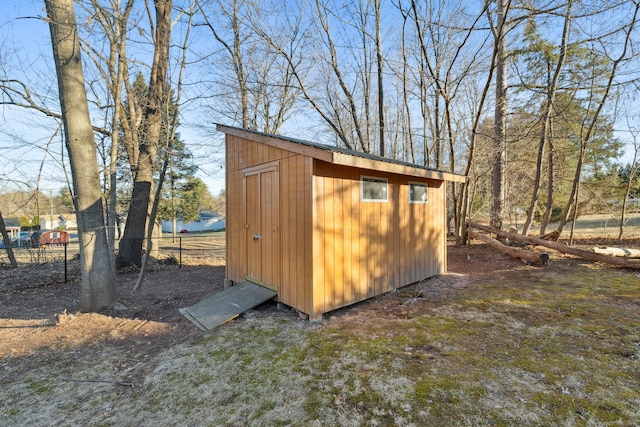 view of shed with fence