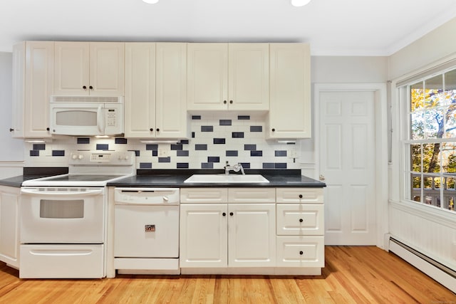 kitchen featuring white appliances, baseboard heating, crown molding, sink, and light hardwood / wood-style floors