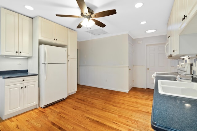 kitchen featuring ornamental molding, white appliances, sink, light hardwood / wood-style floors, and white cabinetry