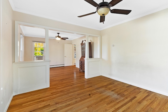 unfurnished room featuring ornamental molding, a baseboard heating unit, and hardwood / wood-style flooring