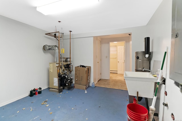 interior space featuring baseboard heating, water heater, and sink