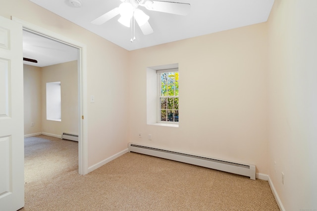 carpeted empty room with baseboard heating and ceiling fan