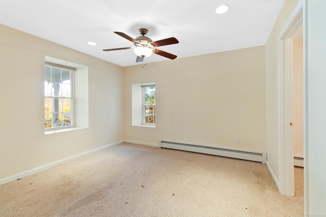 unfurnished room featuring ceiling fan, baseboard heating, and light carpet