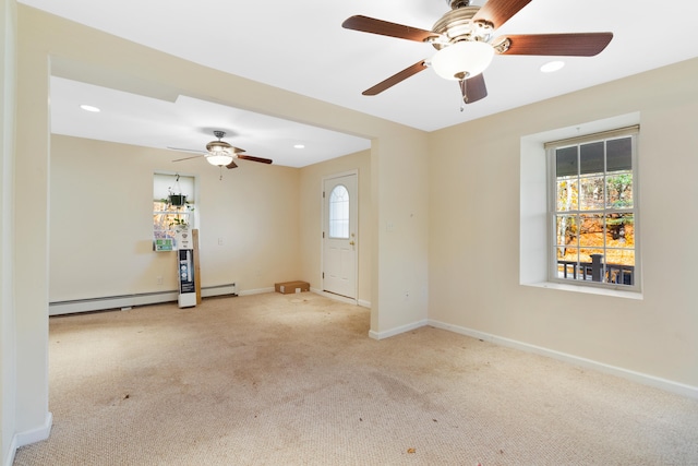 carpeted spare room featuring a baseboard heating unit