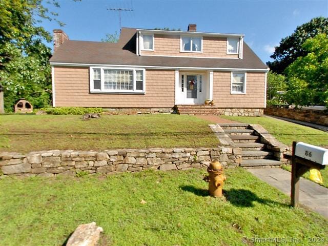86 Vanguard St, Bridgeport, CT 06606 - view of front of home with a chimney and a front yard