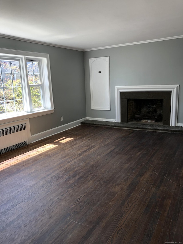 unfurnished living room with radiator, dark hardwood / wood-style floors, and ornamental molding