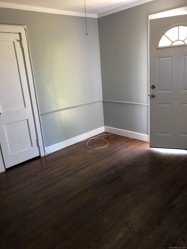 foyer featuring dark hardwood / wood-style floors and ornamental molding