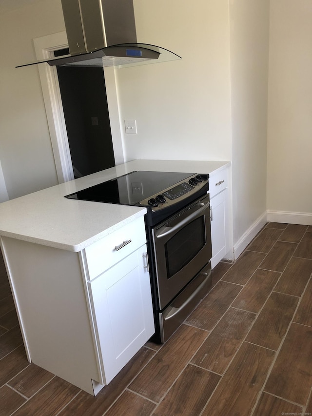86 Vanguard St, Bridgeport, CT 06606 - kitchen with stainless steel range with electric cooktop, island range hood, wood finish floors, and white cabinets