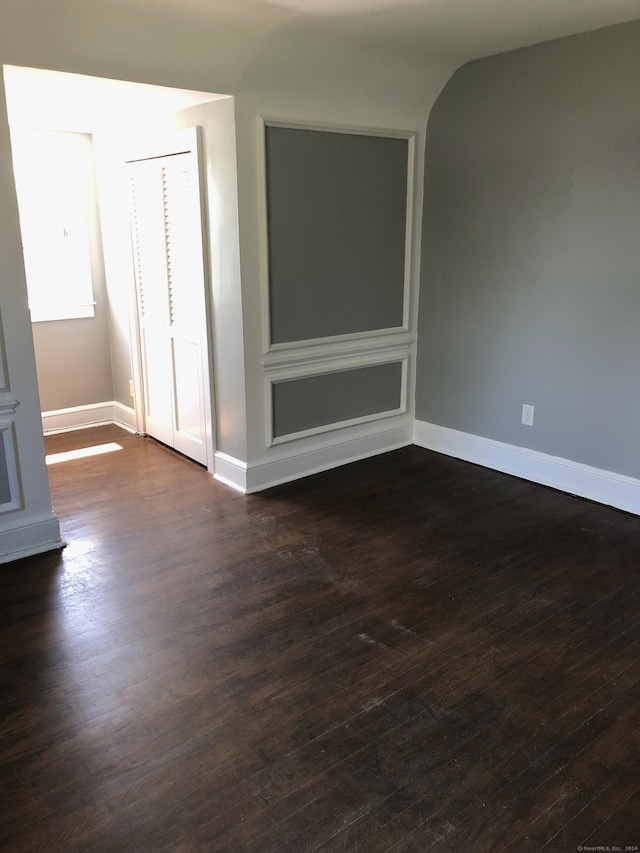 spare room featuring dark wood-type flooring