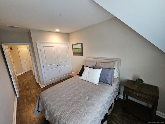 bedroom featuring dark hardwood / wood-style floors and a closet