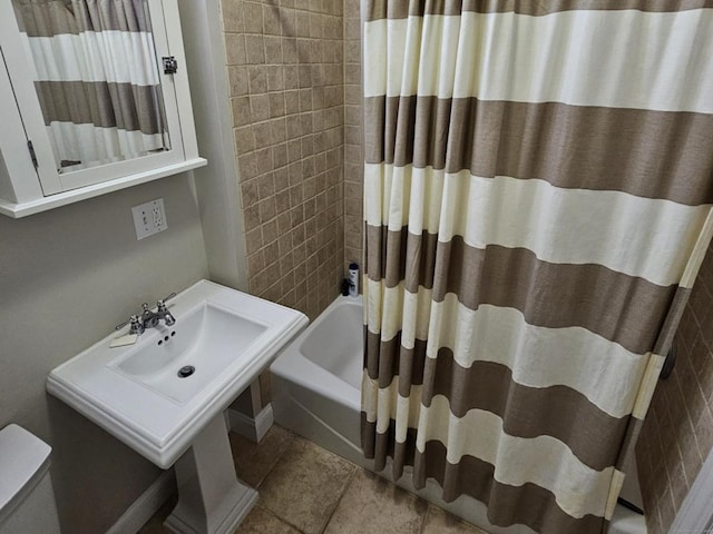 full bathroom with tile patterned flooring, shower / bath combination with curtain, toilet, and sink