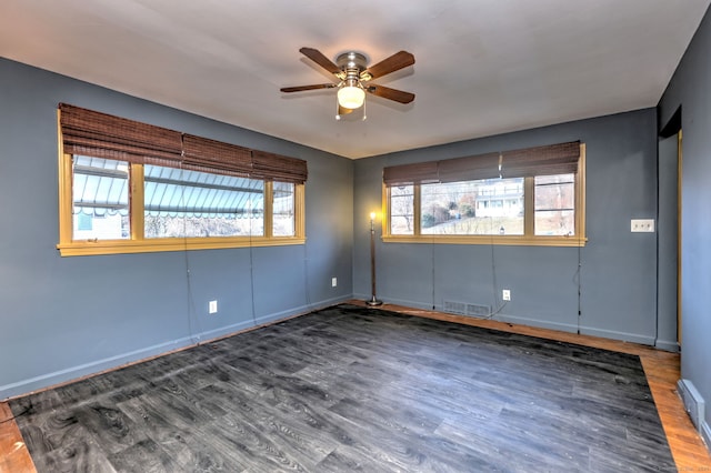 spare room featuring ceiling fan and dark hardwood / wood-style floors