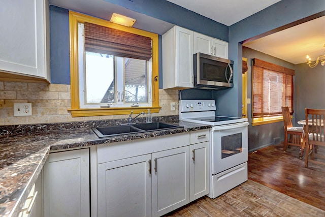 kitchen with white cabinetry, electric range, sink, and light hardwood / wood-style floors