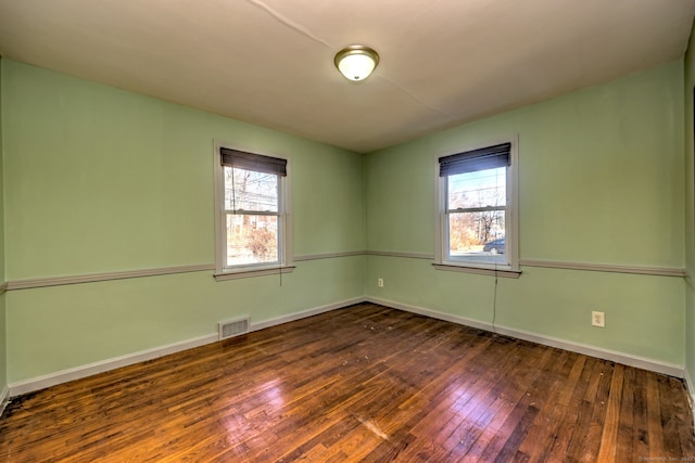 unfurnished room with dark hardwood / wood-style floors