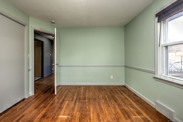 spare room featuring dark hardwood / wood-style floors