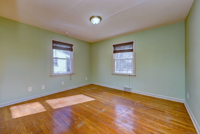 unfurnished room with light hardwood / wood-style floors