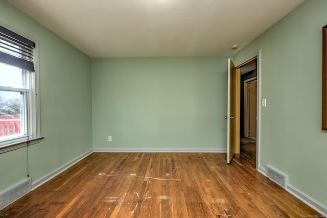 unfurnished room featuring hardwood / wood-style flooring