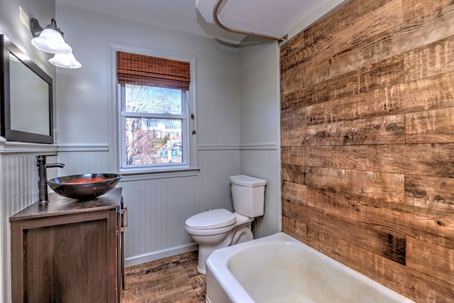 bathroom with vanity, a bathtub, and toilet